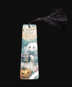 Bookmark with black tassel, coffee-loving ghost, pumpkin and Coffee Because Adulting Is Hard wording on a teal background