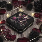 Gothic fairy black tin lifestyle shot with rose petals and fairy lights