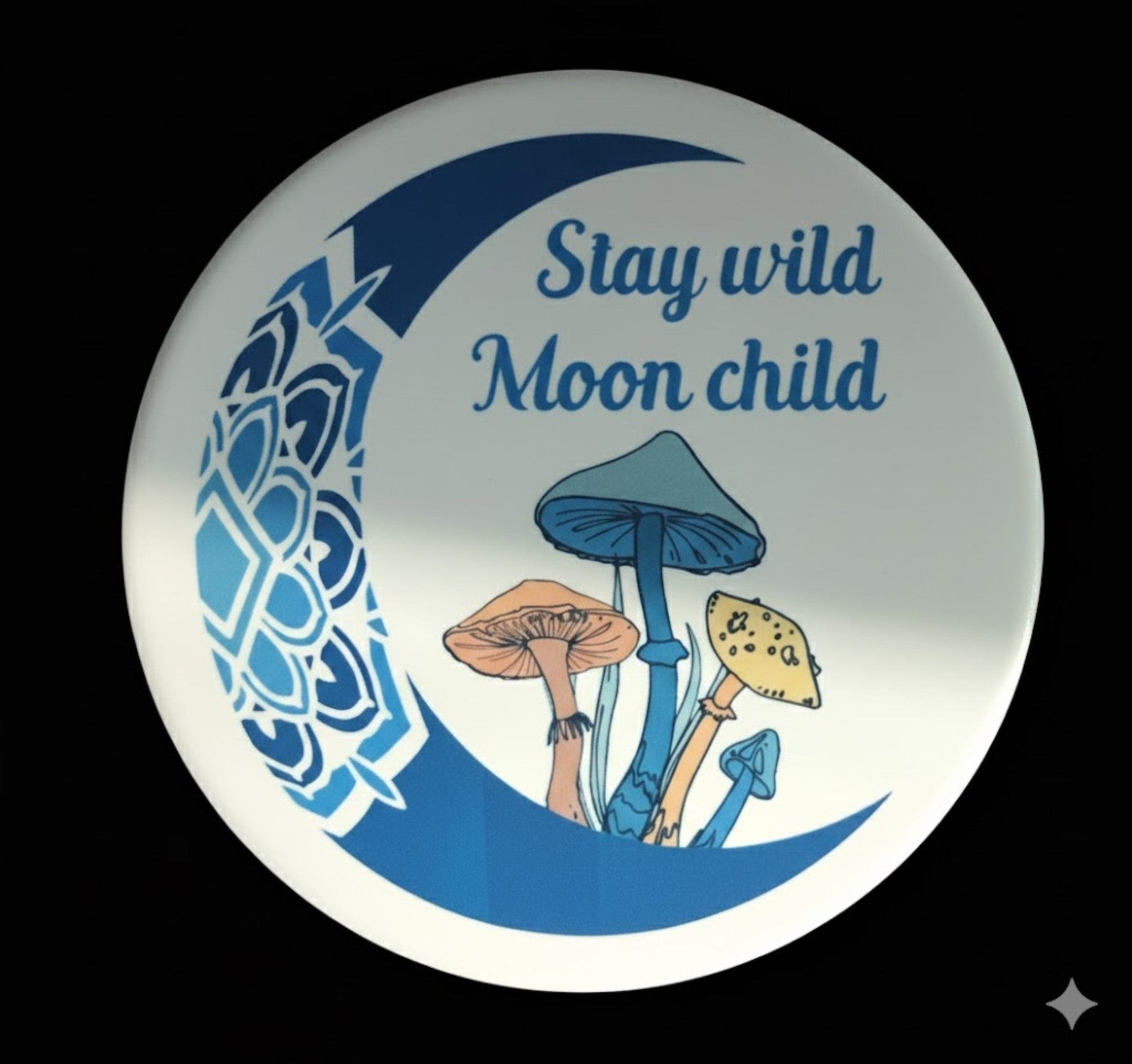 Coaster with mushrooms and 'Stay wild Moon child' text on a blue crescent moon design.