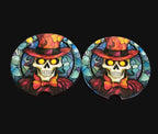 Two colorful skull coasters with hats and bow ties on a wooden surface