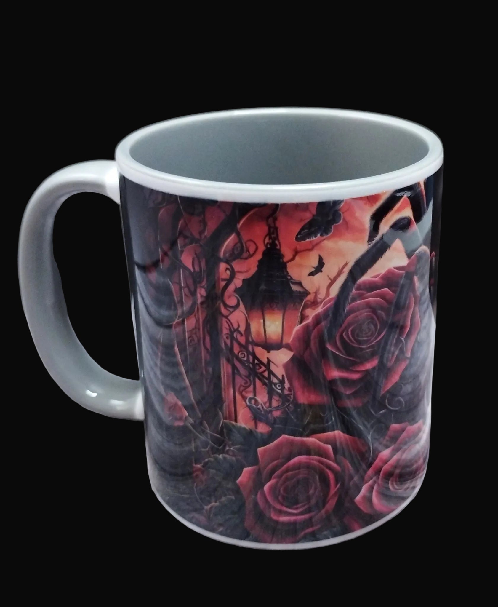 Mug with gothic design featuring roses and a clock on a wooden surface.