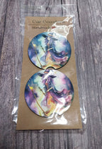 Two round car coasters with artistic designs on a cardboard backing labeled 'Car Coasters Handmade'.