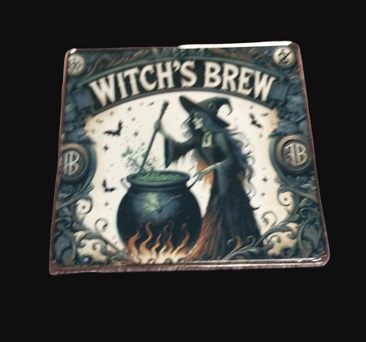 Witch's Brew square metal fridge magnet featuring a witch stirring a cauldron with bats, gothic botanical details and the text Witch's Brew